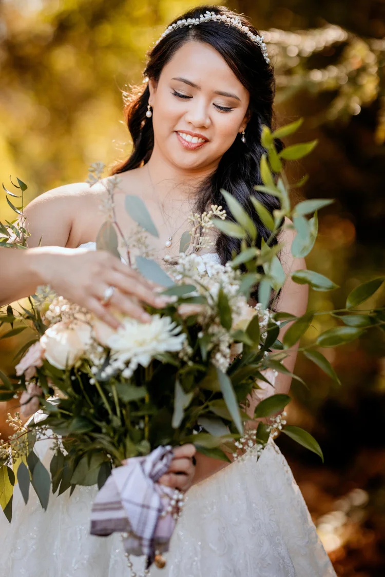 Soft bridal eye makeup and pink lips in an outdoor wedding portrait.